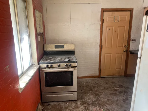 a kitchen with stainless steel appliances granite countertop a stove and a refrigerator