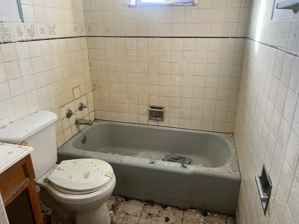 a view of a small space with wooden floor and a window