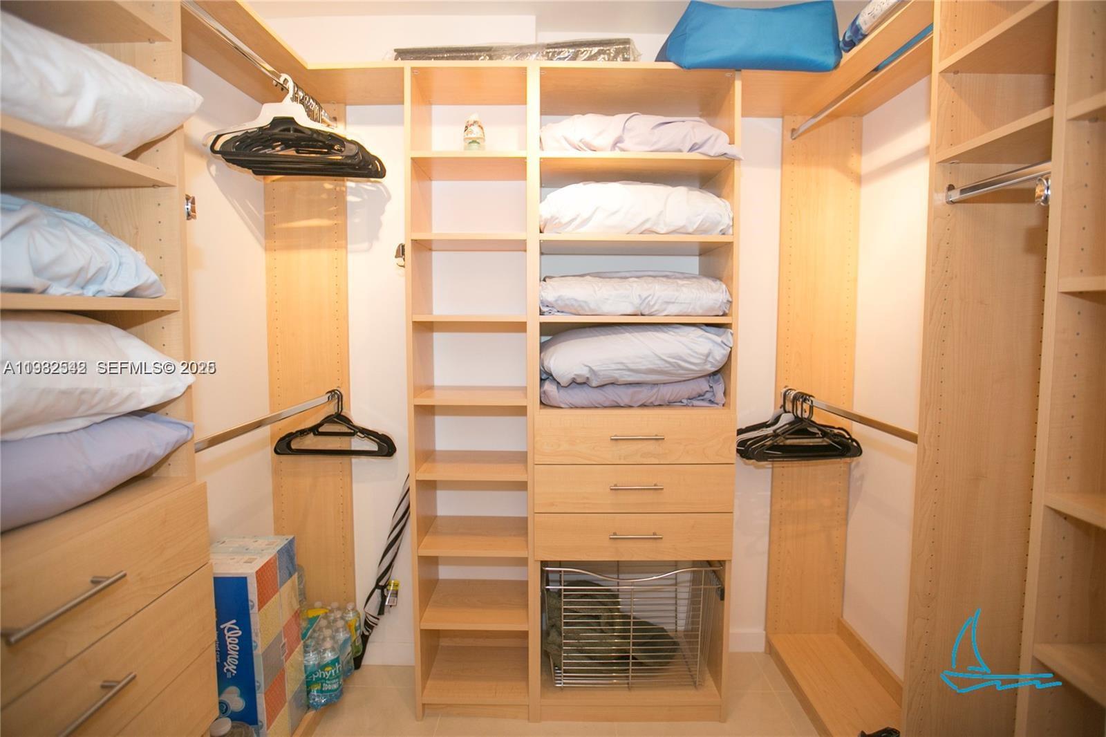 8877 Collins Avenue, Unit 805 Surfside, FL 33154 - Photo 11 of 30 a view of walk in closet with clothes and shoes