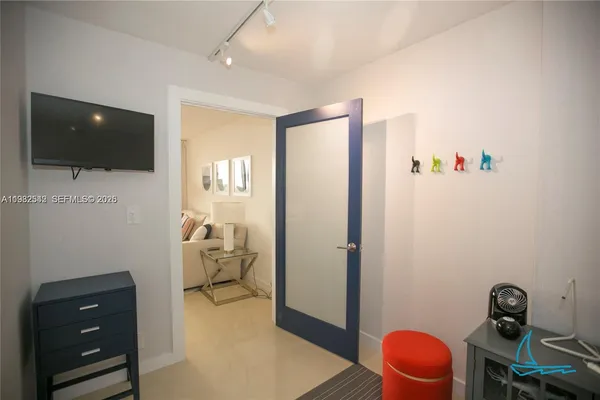 a bedroom with a bed and a painting on the wall