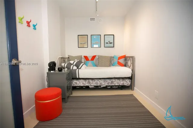 a living room with furniture and a painting on the wall