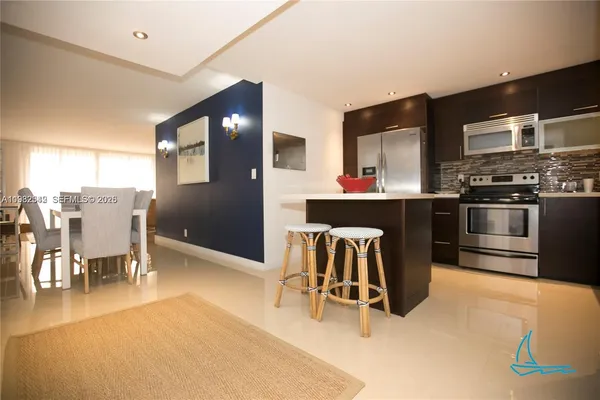a kitchen with stainless steel appliances a refrigerator and a stove