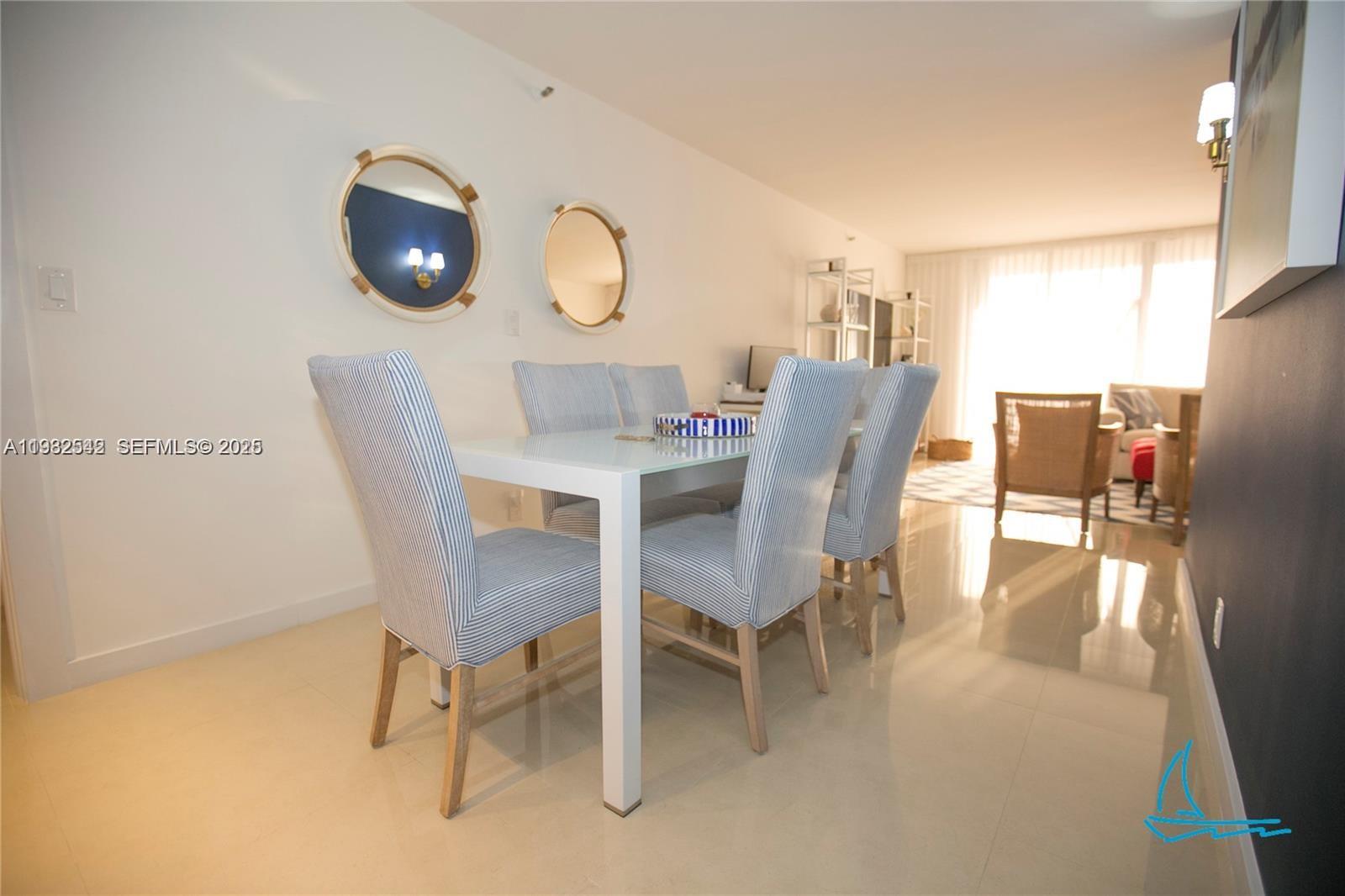 8877 Collins Avenue, Unit 805 Surfside, FL 33154 - Photo 7 of 30 a view of a dining room with furniture and wooden floor