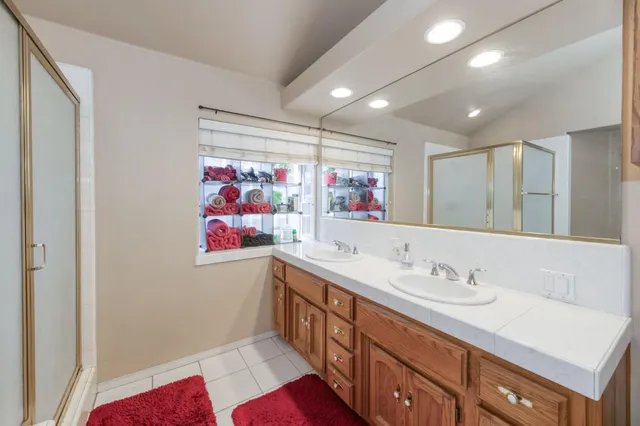 a view of a backyard with large trees and wooden fence