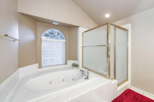 a view of a swimming pool with couches and table in the patio