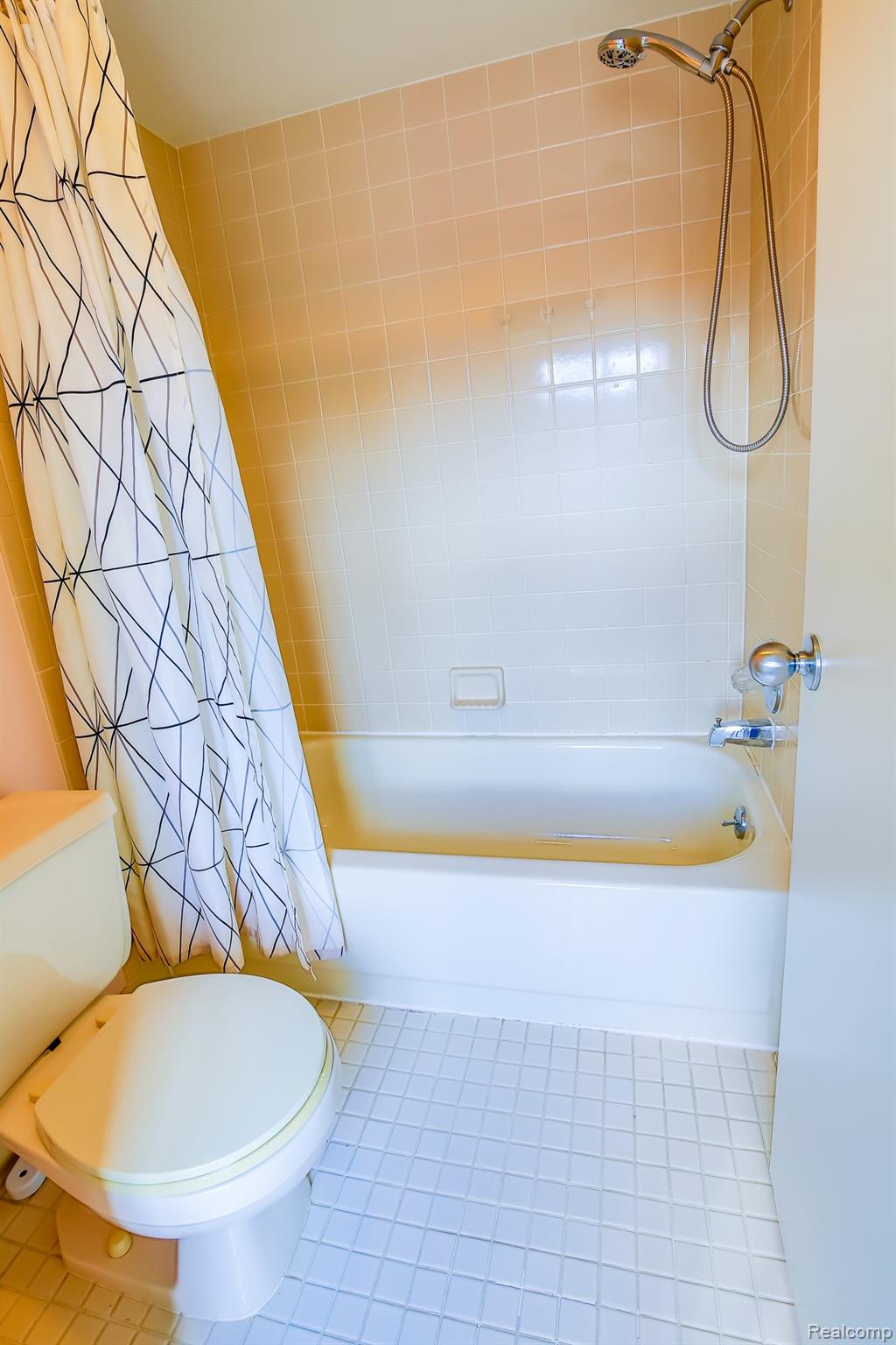 716 Eton Court Rochester, MI 48307 - Photo 19 of 41 White square tile flooring bathroom in the 2nd suite with a bathtub & showing