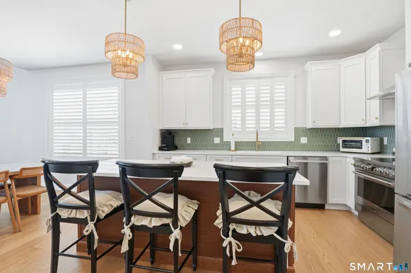 a view of a dining room with furniture and chandelier