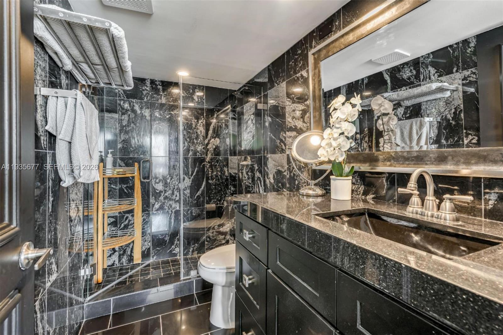 555 Northeast 15th Street, Unit 30H Miami, FL 33132 - Photo 11 of 39 a bathroom with a sink a toilet and shower