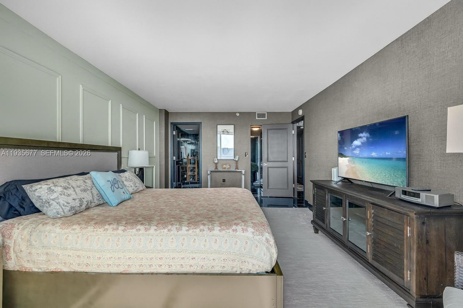 555 Northeast 15th Street, Unit 30H Miami, FL 33132 - Photo 9 of 39 a bedroom with a large bed and a flat screen tv