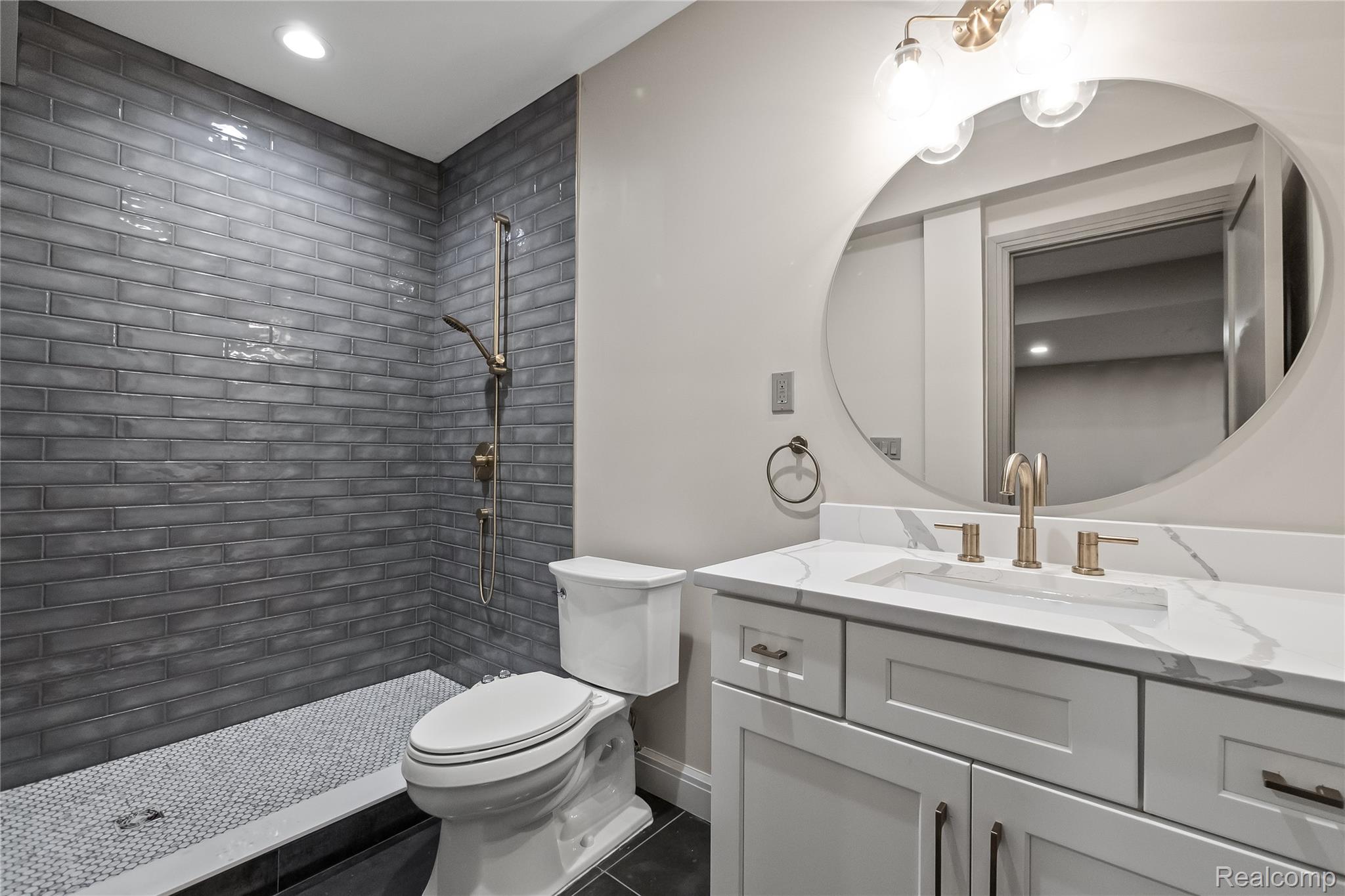 3824 Poppleton Street Troy, MI 48084 - Photo 38 of 51 Bathroom featuring vanity, a tile shower, dark tile patterned floors, and recessed lighting