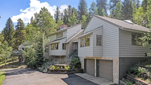 a kitchen with a sink dishwasher a stove a dining table and chairs with wooden floor