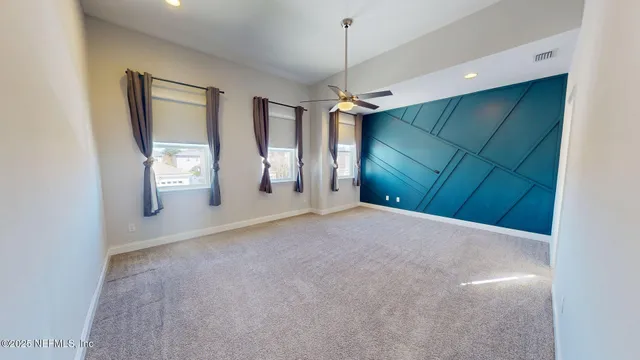 a view of an empty room with window and cabinet
