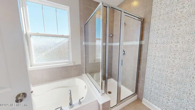 a bathroom with a bathtub and a shower