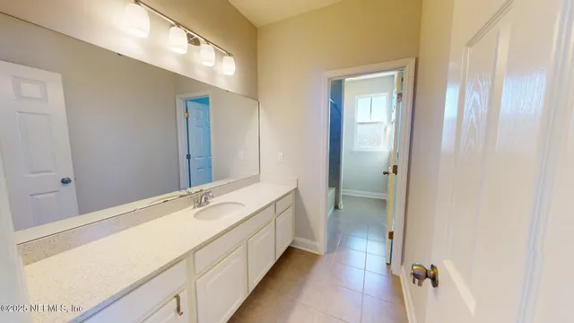 a bathroom with a tub sink and mirror
