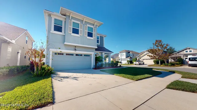 a front view of house with yard and green space