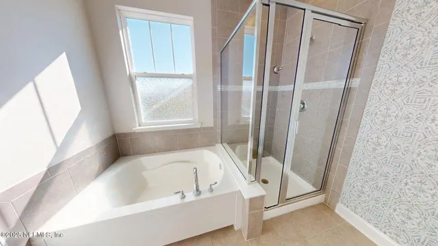 a bathroom with a bathtub and a shower