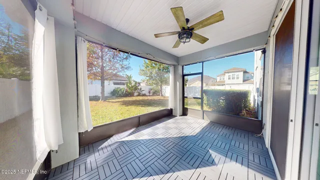 a view of a livingroom with a ceiling fan and a large window