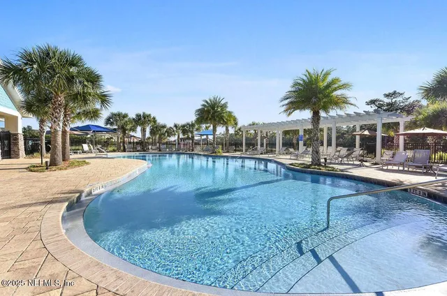 a view of a swimming pool with outdoor seating