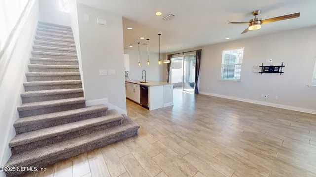 a view of an entryway with wooden floor and staircase