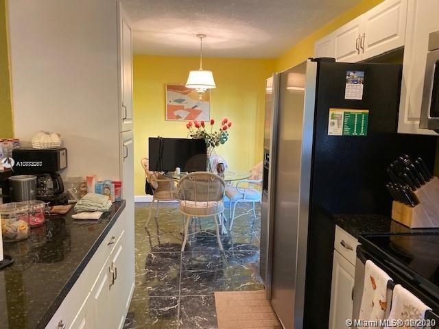 3448 Spring Bluff Place, Unit 27 Lauderhill, FL 33319 - Photo 11 of 24 a kitchen with a sink and cabinets