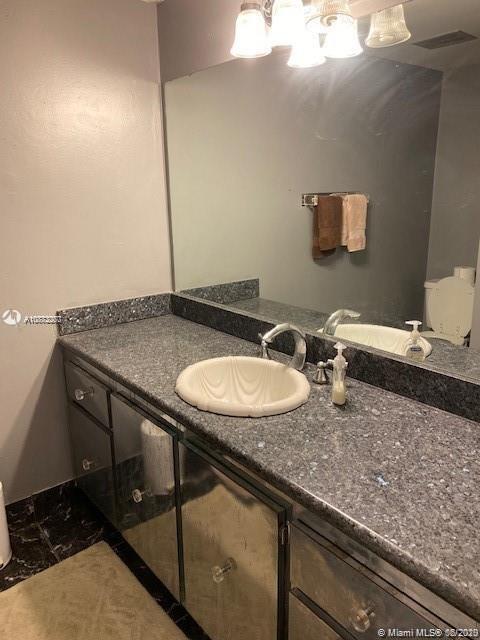 3448 Spring Bluff Place, Unit 27 Lauderhill, FL 33319 - Photo 14 of 24 a bathroom with a granite countertop sink and a mirror