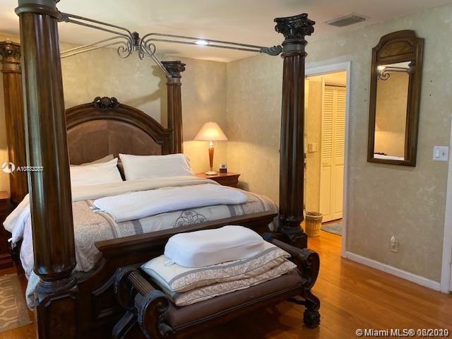 3448 Spring Bluff Place, Unit 27 Lauderhill, FL 33319 - Photo 16 of 24 a bedroom with a bed and a mirror