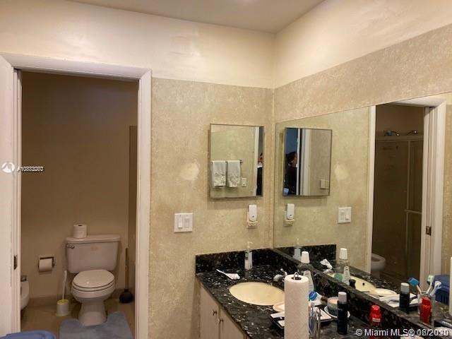 3448 Spring Bluff Place, Unit 27 Lauderhill, FL 33319 - Photo 17 of 24 a bathroom with a granite countertop sink and a mirror
