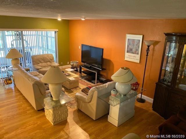 3448 Spring Bluff Place, Unit 27 Lauderhill, FL 33319 - Photo 6 of 24 a living room with furniture and a flat screen tv