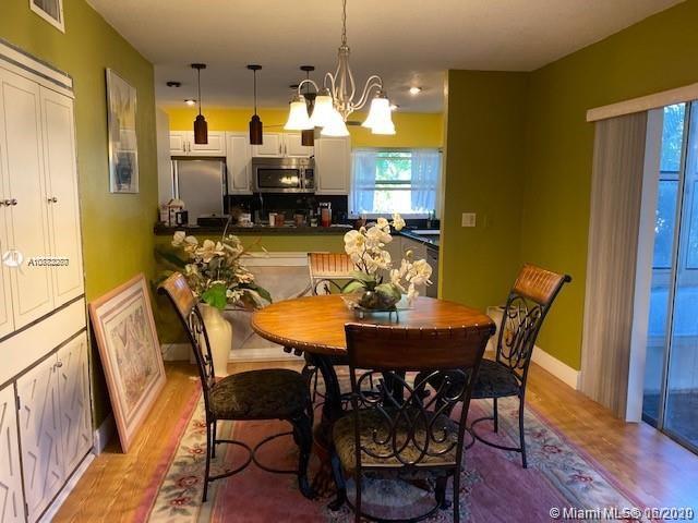 3448 Spring Bluff Place, Unit 27 Lauderhill, FL 33319 - Photo 8 of 24 a view of a dining room with furniture and wooden floor