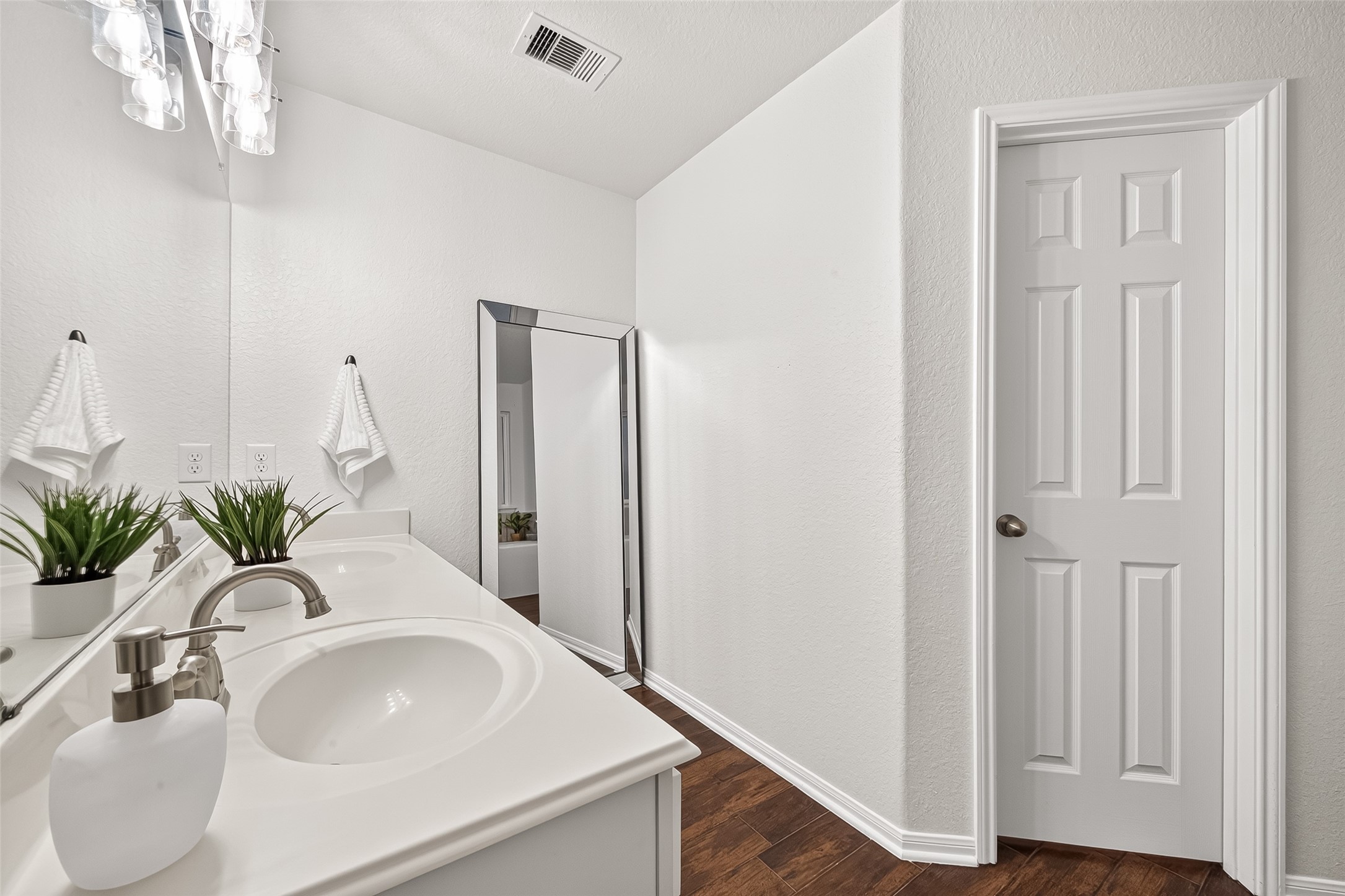 3155 View Valley Trail Katy, TX 77493 - Photo 33 of 50 Spa-like primary bathroom featuring a large vanity, modern lighting, and a crisp, clean aesthetic