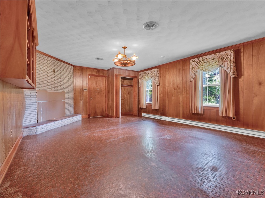 8901 Strath Road Henrico, VA 23231 - Photo 29 of 47 Spare room with a fireplace, baseboard heating, an