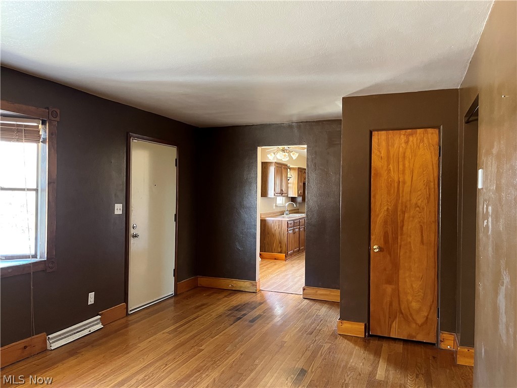 Unfurnished bedroom with light hardwood, Bay wiindow & coat closet
