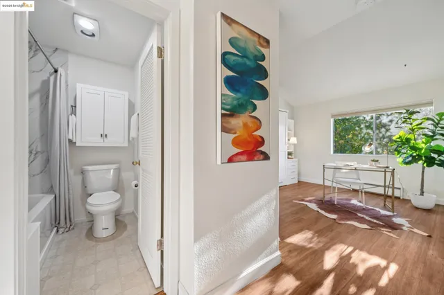 a vase of flowers sitting on a table with a potted plant