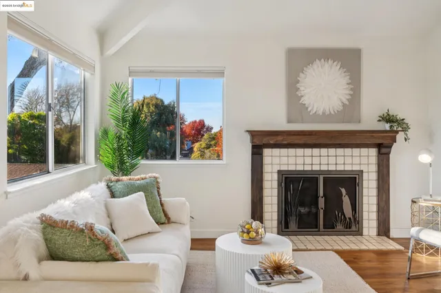 a living room with furniture a fireplace and a floor to ceiling window