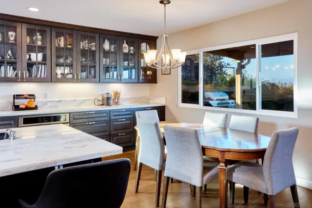 a dining room with furniture a chandelier and window