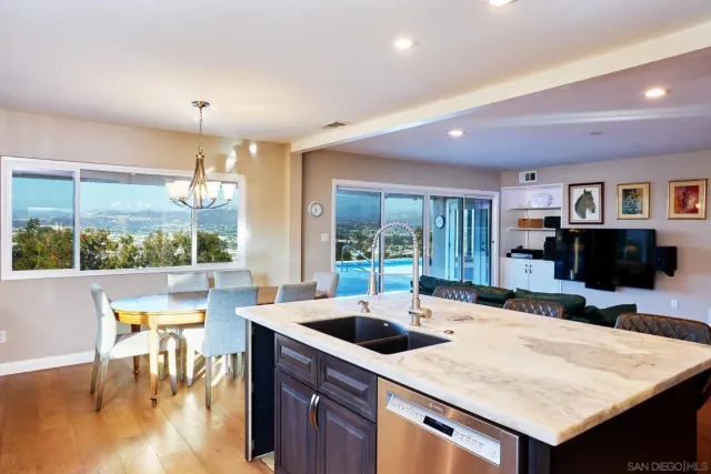 a kitchen with a table chairs and a barbeque