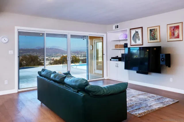 a living room with furniture and a floor to ceiling window