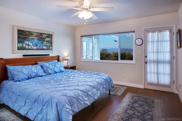 a bedroom with a large bed and a window