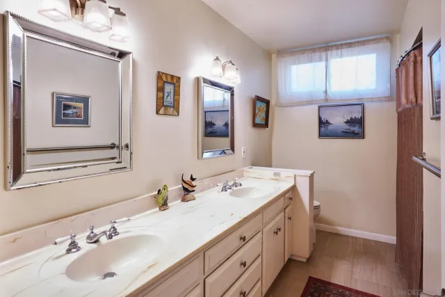 a bathroom with a double vanity sink and a mirror