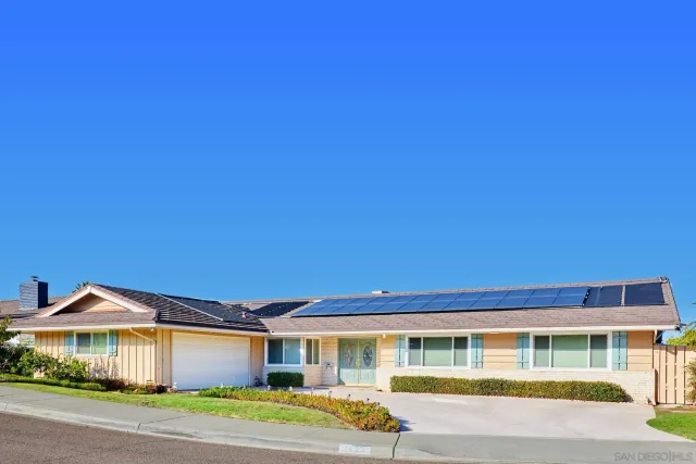 a front view of a house with a yard and balcony
