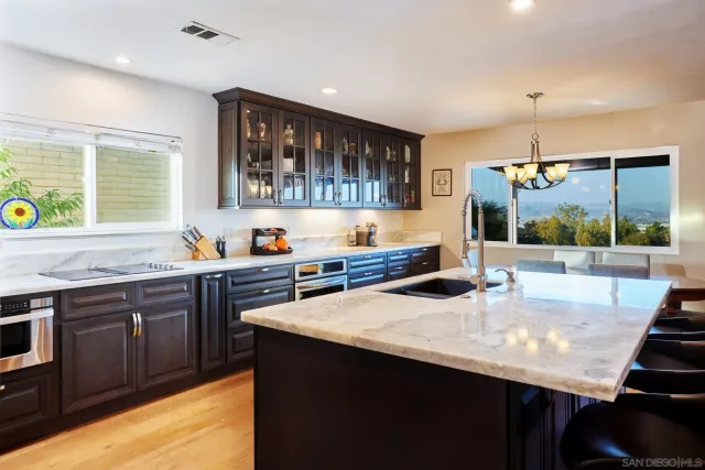 a kitchen with a sink a stove and cabinets
