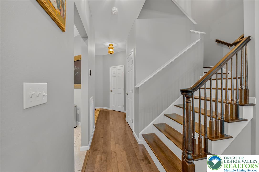 4236 Creek Road Allentown, PA 18104 - Photo 7 of 47 Gleaming hardwood floors guide you past the elegant staircase in this welcoming entryway.