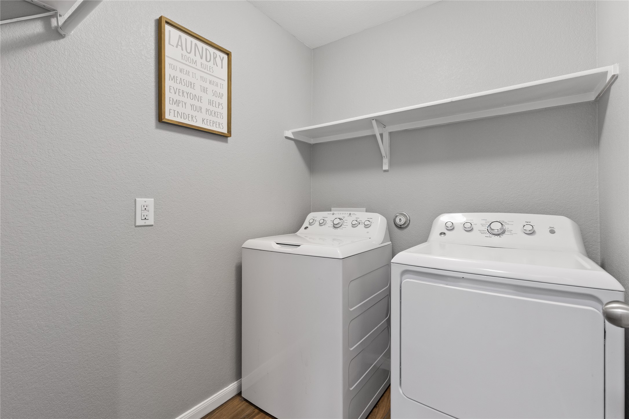 256 Alpha Kyle, TX 78640 - Photo 20 of 27 A dedicated laundry space boasts essential appliances and practical shelving for organization.