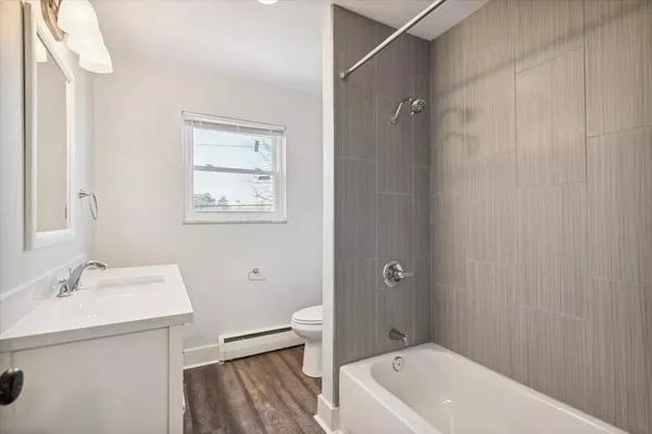 a bathroom with a sink a toilet and shower