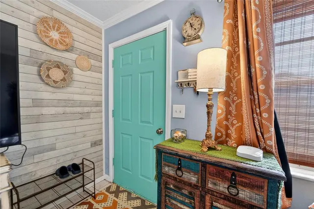 a living room with lots of furniture and view of kitchen