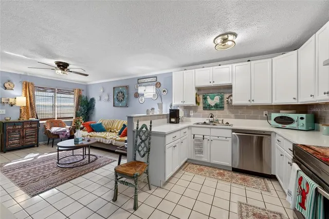 a kitchen with cabinets appliances a sink and a counter top