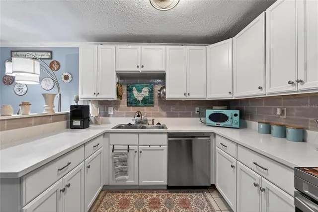 a stove top oven sitting inside of a kitchen
