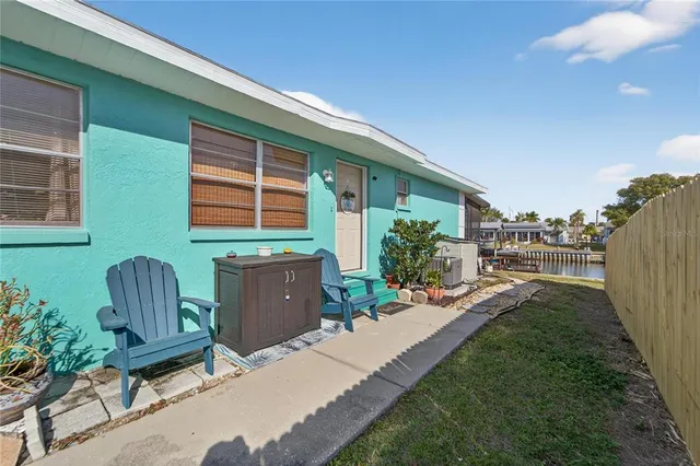 a view of a house with backyard sitting area and garden