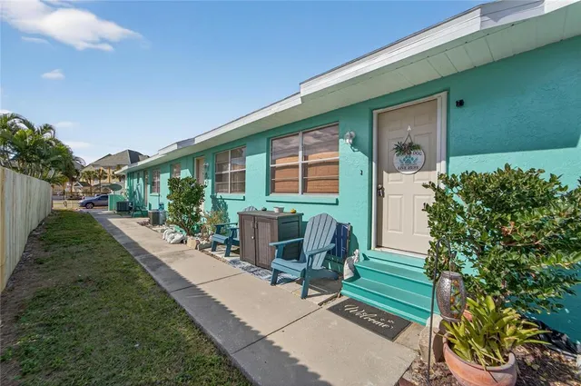 a view of a deck with chairs and potted plants