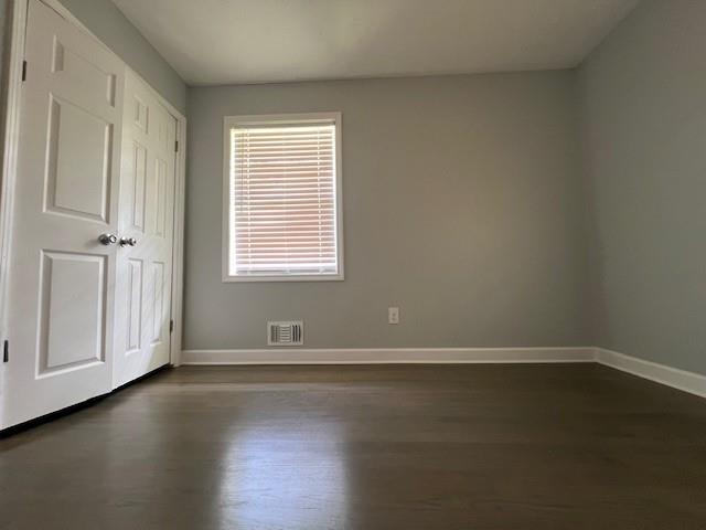 6935 Fielder Road Rex, GA 30273 - Photo 17 of 22 an empty room with wooden floor and windows